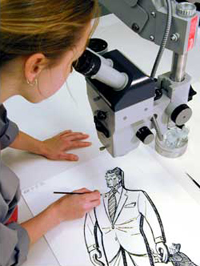 Kaare Chaffee, a conservator for the Library, consolidates layers of media to stabilize drawings for the Herblock exhibition.