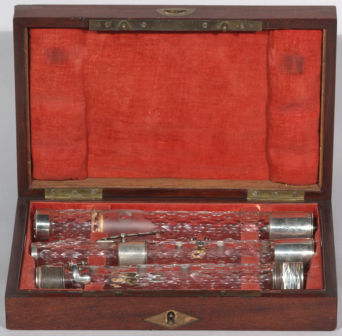 Instrument type: Flute in C. Medium: Clear glass, silver keys and ferrules, safety locks. Clear glass faceted end cap with hemispherical silver reflector behind, held in place by a silver ring. Key Holes System: 4 keys, round flat curved flaps, post and rod on silver flanges.   Mark Maximum: Laurent / à Paris, / 1813. (cursive)   Mark Additional: Mark on lower body. Mark on head: A.S.E. James Madison / President des Etats=unis.