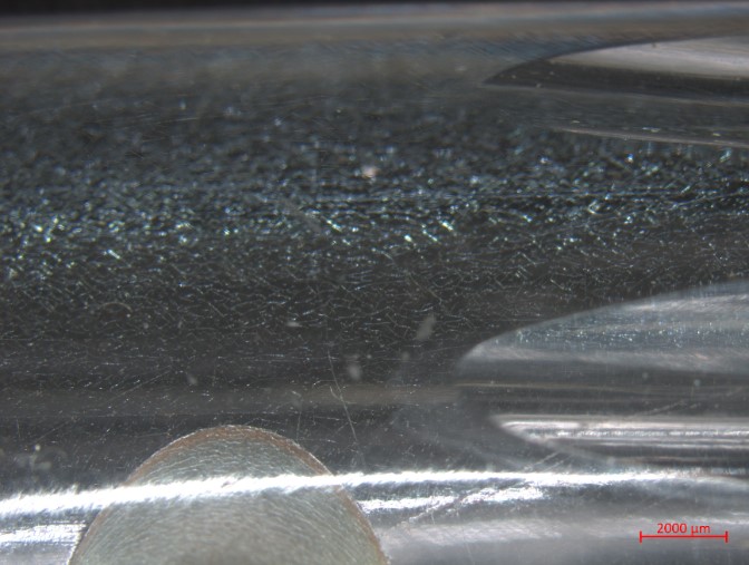 Microscope image of deterioration in the form of microcracking seen through the glass on the interior of a flute by Claude Laurent, dated 1814