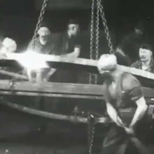 Workers lifting a large metal frame