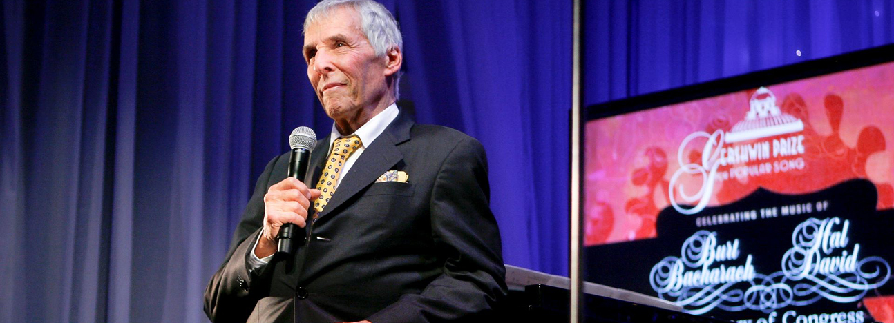 man standing at piano