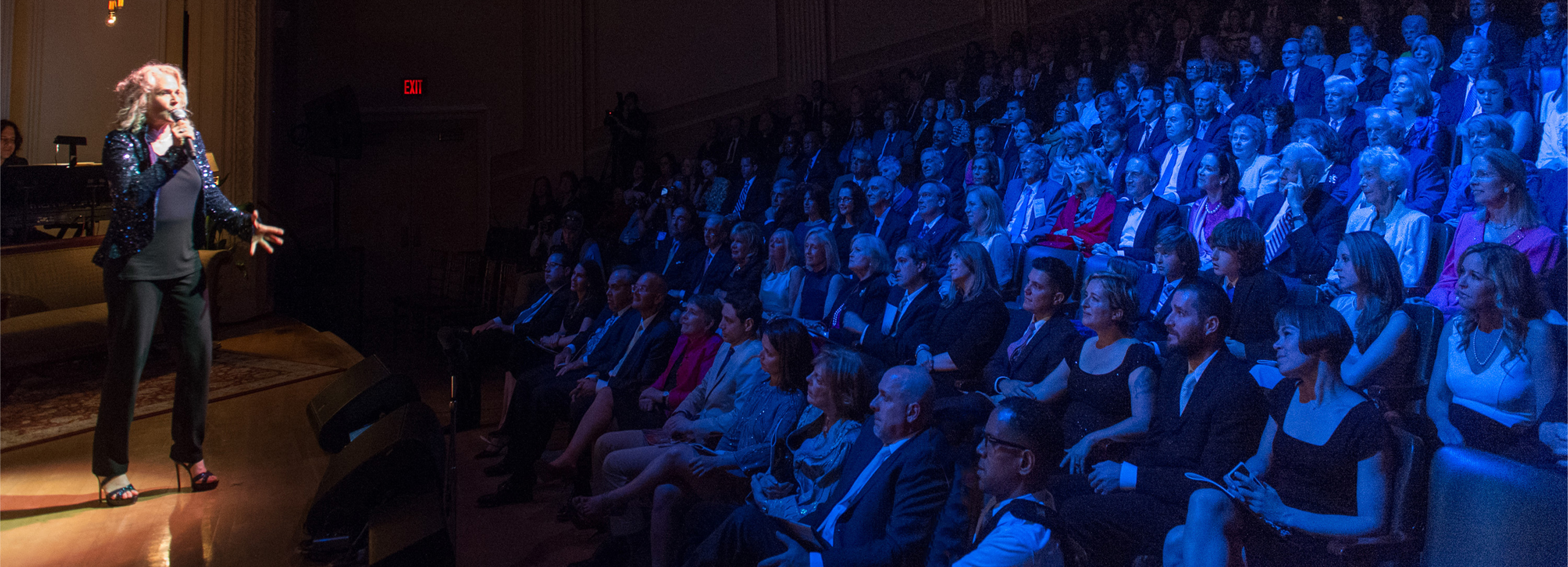 Carole King performing onstage to a captivated audience