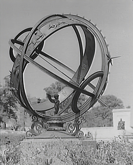 A large open sphere with metal rings and signs of the zodiac. 
