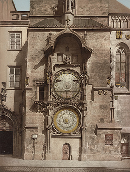 Color print shows an old  building with three large clocks, one above the other.
