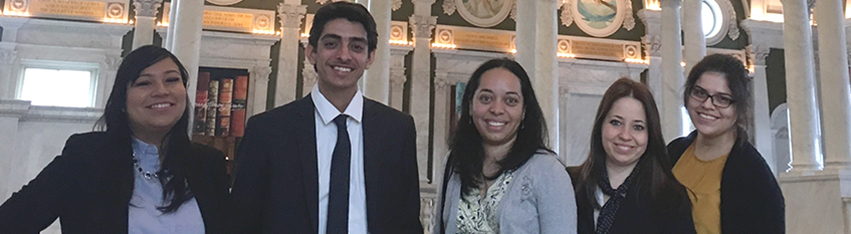 Five interns standing in the Great Hall