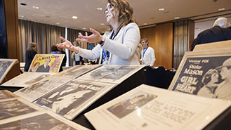 Men with pickaxes and women and children gathering oysters at coast.
