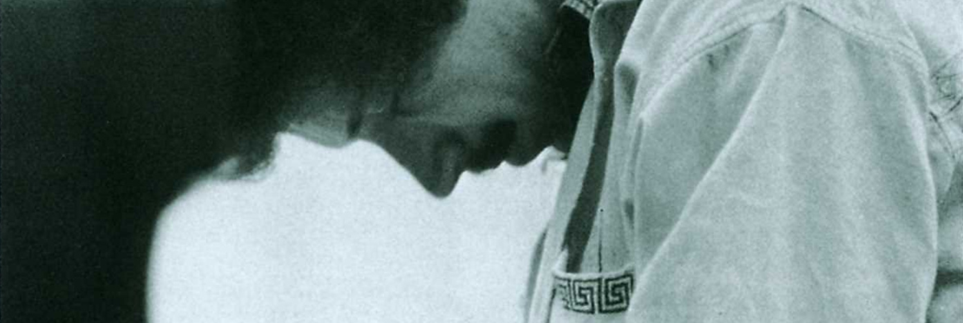 album cover with man hunched over piano