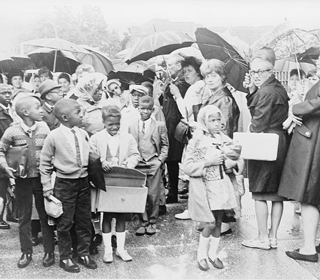 African American children on way to Primary School 204, 82nd Street and 15th Avenue NY, pass mothers protesting the busing of children to achieve integration
