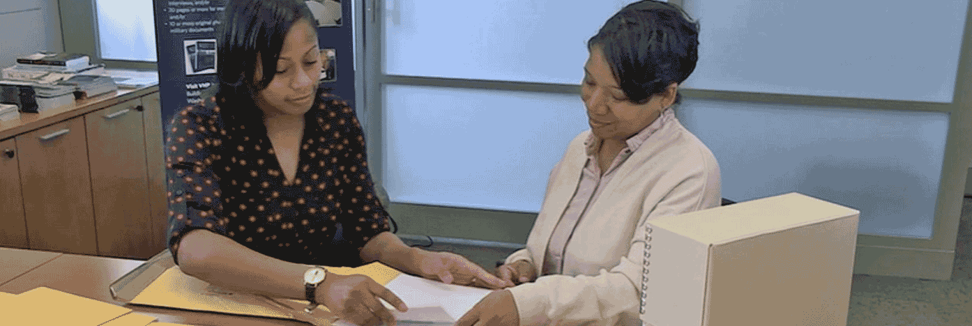 Two women reviewing documents at an office desk