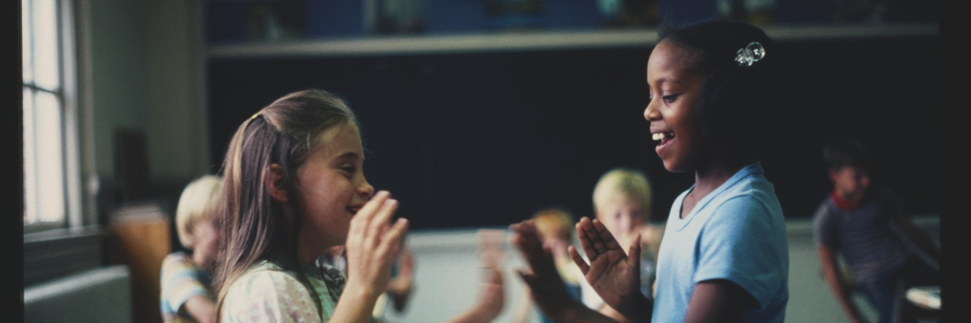 Two children playing in a classroom